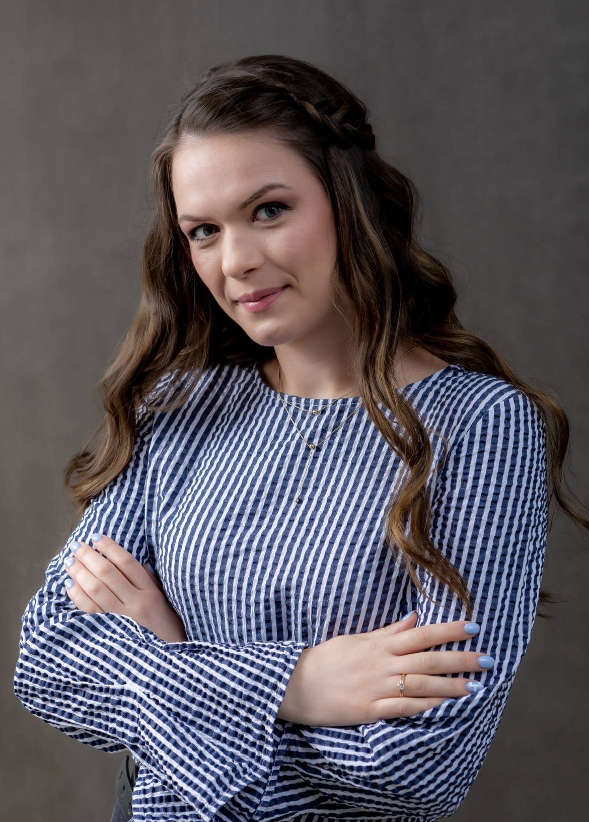 Patricia in blue and white striped shirt.